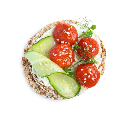 Crunchy buckwheat cakes with cream cheese, tomatoes and cucumber slices isolated on white, top viewの写真素材