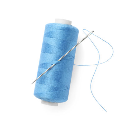 Spool of light blue sewing thread with needle isolated on white, top viewの写真素材