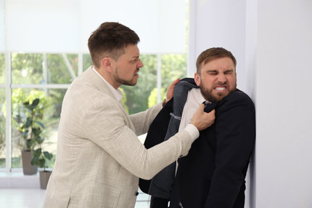 Emotional colleagues fighting in office. Workplace conflict