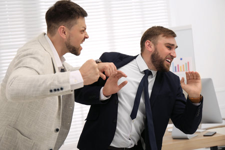 Emotional colleagues fighting in office. Workplace conflict