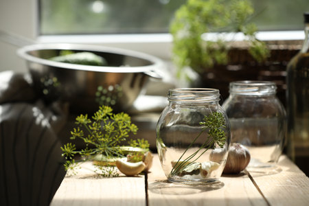 Empty glass jars and ingredients prepared for canning on wooden table indoorsの写真素材