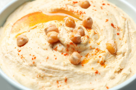Tasty hummus with garnish in bowl, closeupの写真素材
