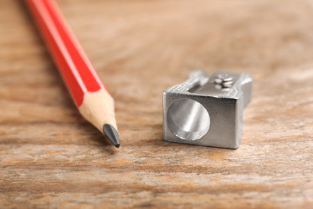 Metal sharpener and pencil on wooden table, closeupの写真素材
