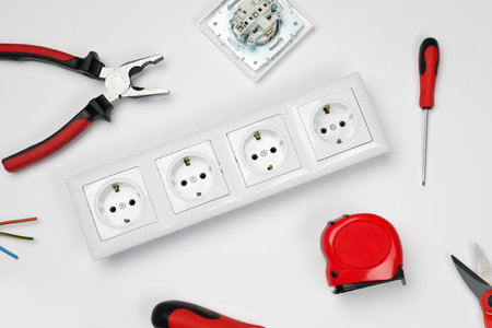 Set of sockets and electrician's tools on white background, top viewの写真素材