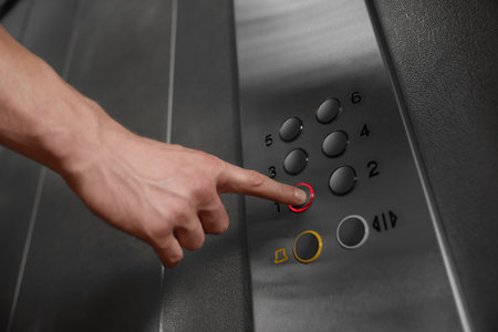 Man choosing floor in elevator, closeup viewの写真素材