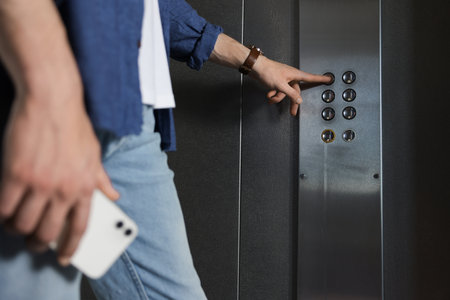 Man choosing floor in elevator, closeup view
