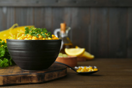 Bowl with tasty boiled corn on wooden table. Space for textの写真素材
