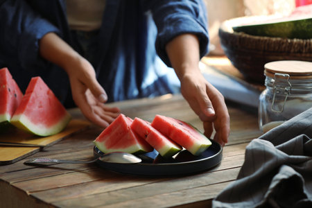 Woman taking plate with slices of fresh watermelon, closeupの写真素材