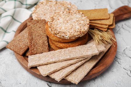 Rye crispbreads, rice cakes and rusks on white textured tableの写真素材