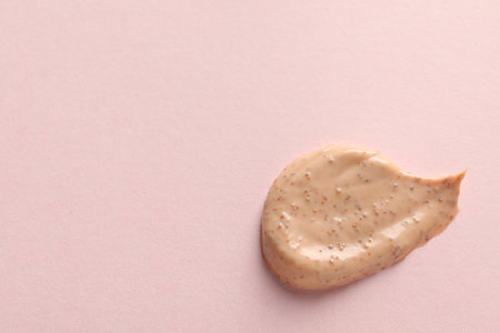 Sample of scrub on pink background, top view. Space for textの写真素材