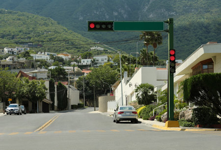 Cars on road near beautiful buildings in mountains. traffic rulesの写真素材