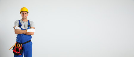 Carpenter with tool belt on light background, space for text. banner designの写真素材