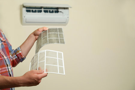 Man holding dirty and clean filters, space for text. home air conditioner cleaning