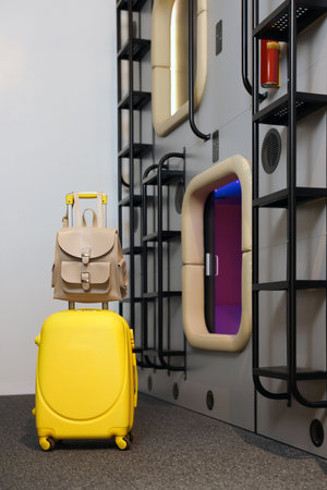 Luggage near capsules in modern pod hostelの写真素材