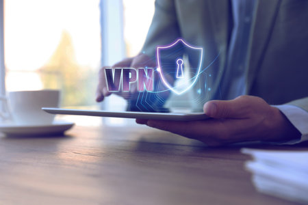 Man using modern tablet with switched on VPN in office, closeupの写真素材