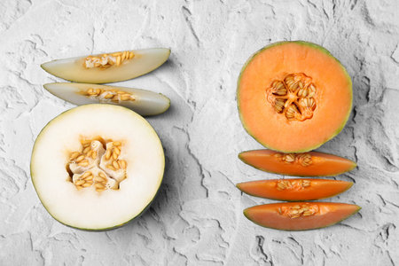 Tasty colorful ripe melons on white textured background, flat layの写真素材