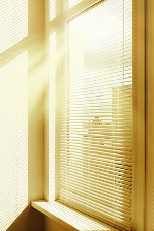 Stylish window with horizontal blinds in roomの写真素材
