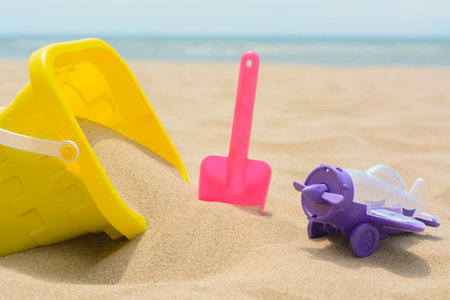 Set of colorful beach toys on sand near sea, closeupの写真素材