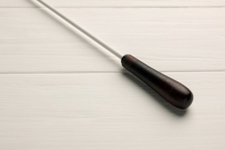Conductor's baton on white wooden table, closeupの写真素材
