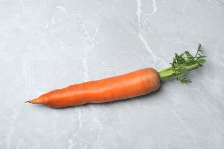 Fresh ripe juicy carrot on light gray marble table, top viewの写真素材