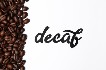 Word Decaf and coffee beans on white background, top viewの写真素材