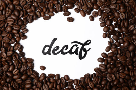 Word Decaf and coffee beans on white background, top viewの写真素材