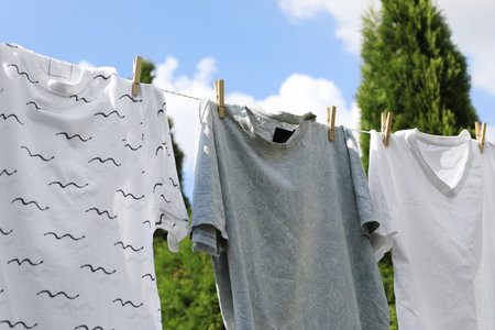 Washing line with clean clothes outdoors. Drying laundry outsideの写真素材