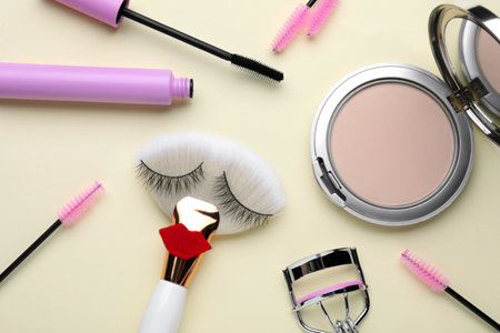Flat lay composition with false eyelashes on gray background