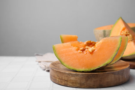Tasty colorful ripe melons on white table, space for textの写真素材