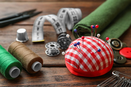 Threads and other sewing supplies on wooden table, closeupの写真素材