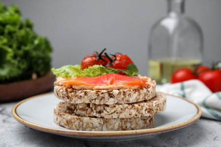 Crunchy buckwheat cakes with salmon, tomatoes and greens on tableの写真素材