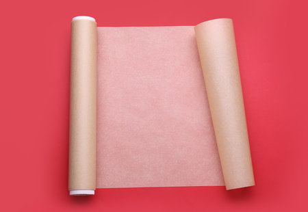 Roll of baking paper on red background, top viewの写真素材
