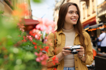 Young woman with camera on city street. interesting hobby