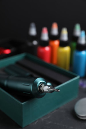 Tattoo equipment and machine in box on black table, closeupの写真素材