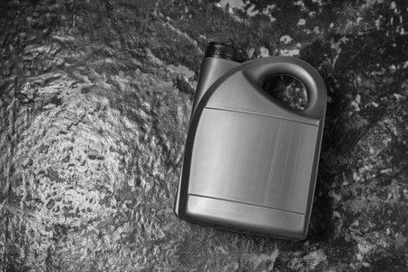 Motor oil in gray canister on black table, top view. Space for textの写真素材