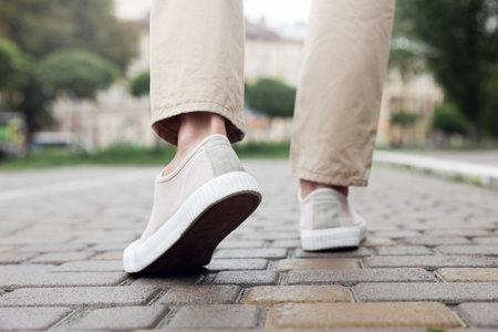 Man in stylish sneakers walking on city street, closeupの写真素材