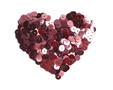 Red sequins isolated on white, top view