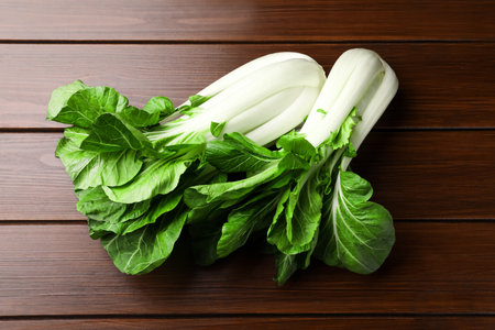 Fresh green pak choy cabbages on wooden table, flat layの写真素材