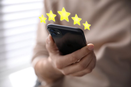 Man with smartphone giving feedback indoors, closeup. customer review