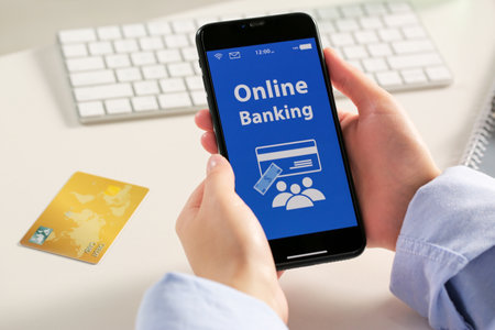 Woman using online banking app on smartphone at white office table, closeup