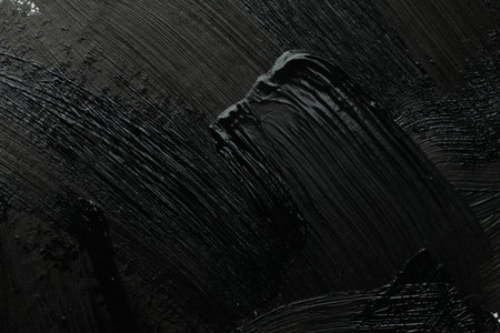 Beautiful strokes of black paint as background, closeup