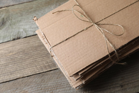 Stack of waste paper on wooden table, above view. Space for textの写真素材