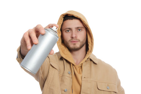 Handsome man holding can of spray paint on white backgroundの写真素材