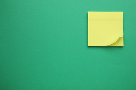 Empty notes on green background, top view. Space for textの写真素材