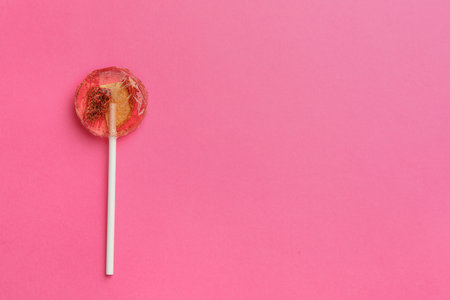 Sweet colorful lollipop with berries on pink background, top view. Space for textの写真素材