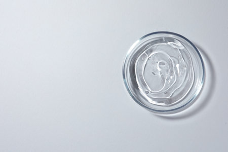 Petri dish with liquid on white background, top view. Space for textの写真素材