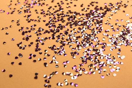 Shiny bright glitter on beige background, closeup
