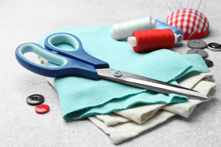 Scissors, spools of threads and sewing tools on white backgroundの写真素材
