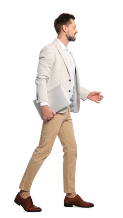 Man with laptop walking on white backgroundの写真素材