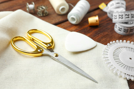 Threads and other sewing supplies on wooden tableの写真素材